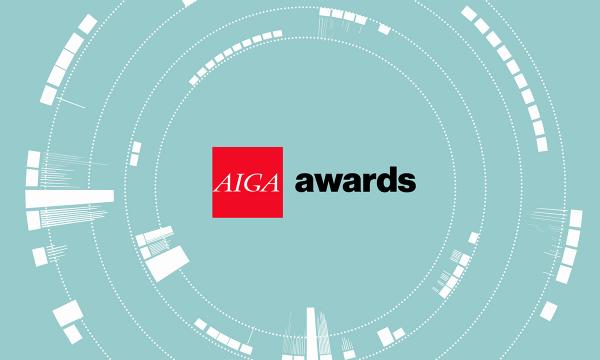 AIGA Awards logo lockup, AIGA letters in white inside a red square box followed by the word awards in lowercase black type against a light turquoise background with concentric white circles that resemble a camera lens.